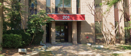 Entrance of 201 Consumers Road, North York, with the red 201 sign over the doors