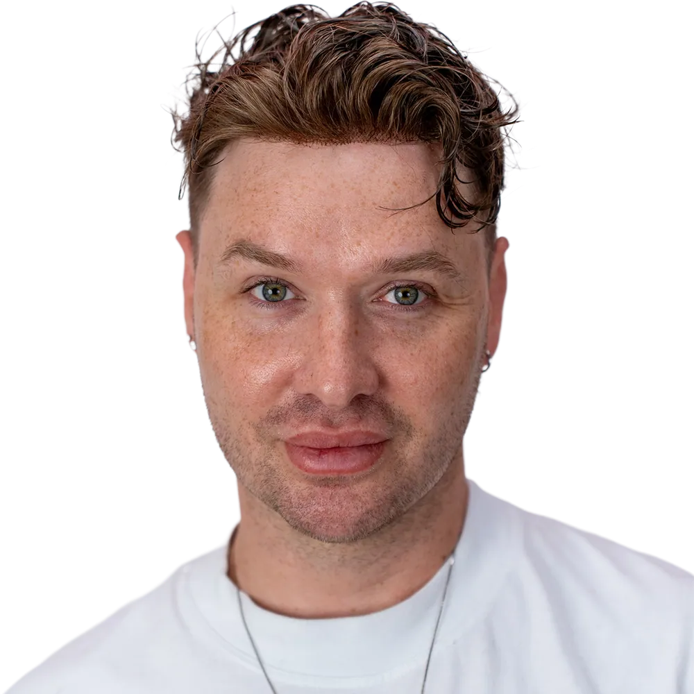 A man photographed wearing a hair system, head and shoulders.